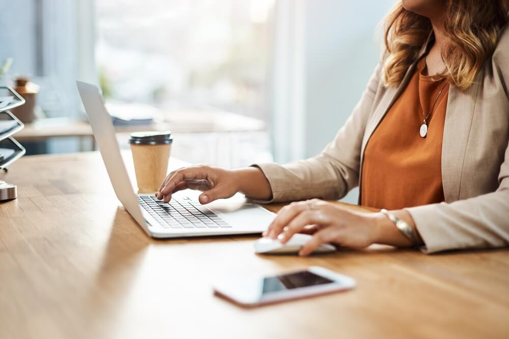 A doctor engaging closely with a patient while administrative documentation is handled by a virtual medical scribe.